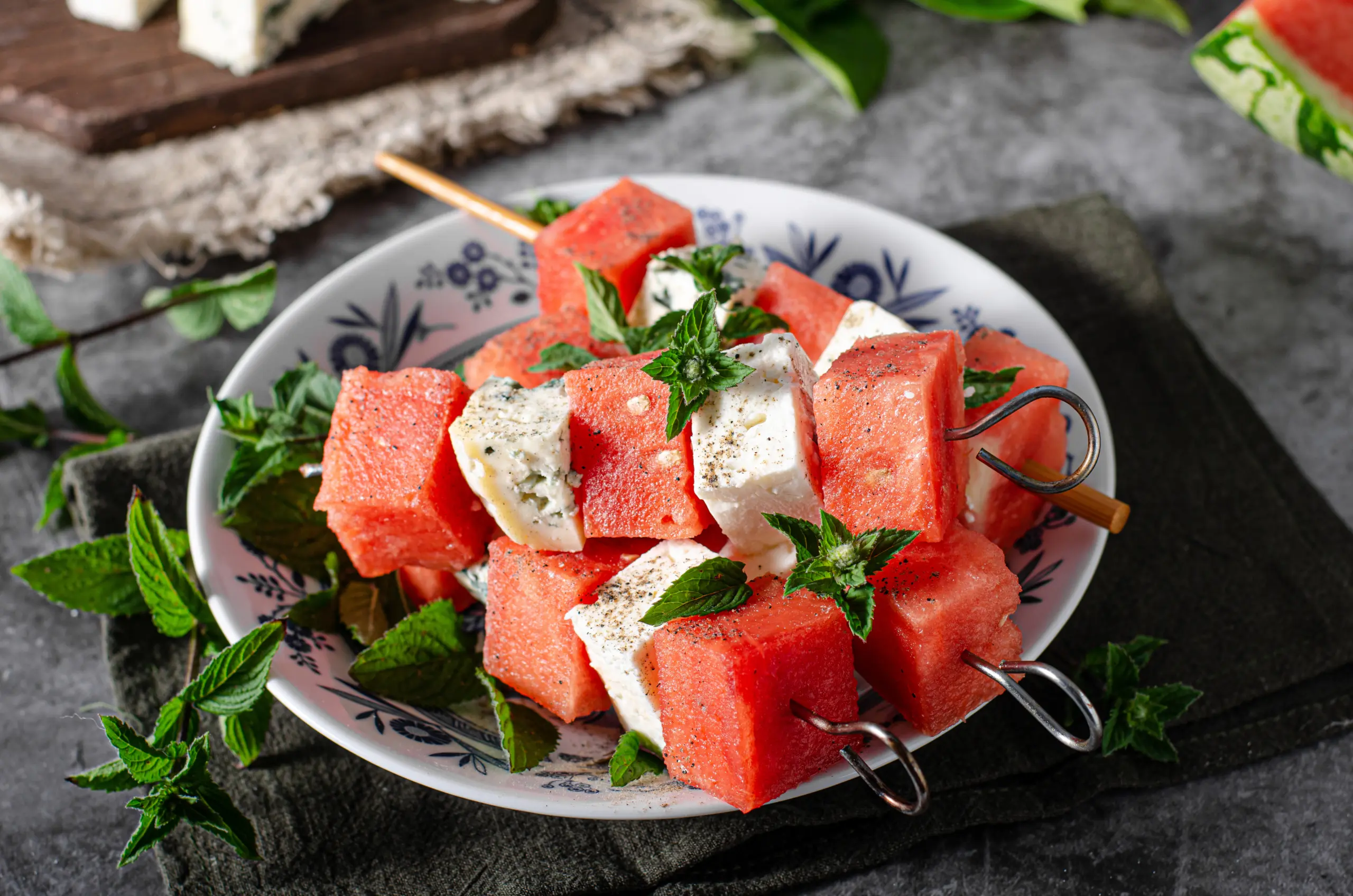 Fresh melon with feta and blue cheese, topped with herbs